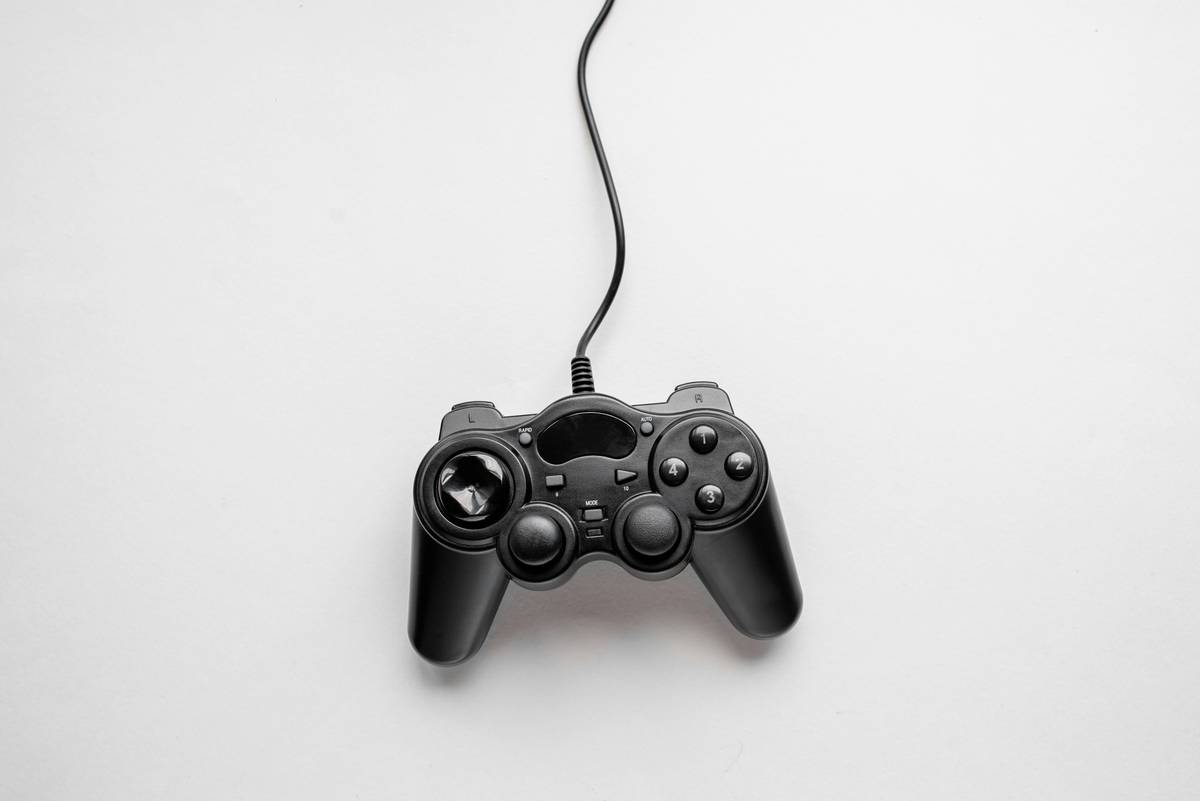 Top View of Black Wired Gamepad Controller Isolated on Minimalist White Background